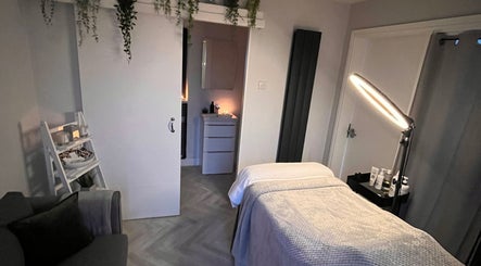 Relaxing treatment room at Rebecca Louise Beauty, Culcheth, England, GB, featuring a massage table and ambient lighting.