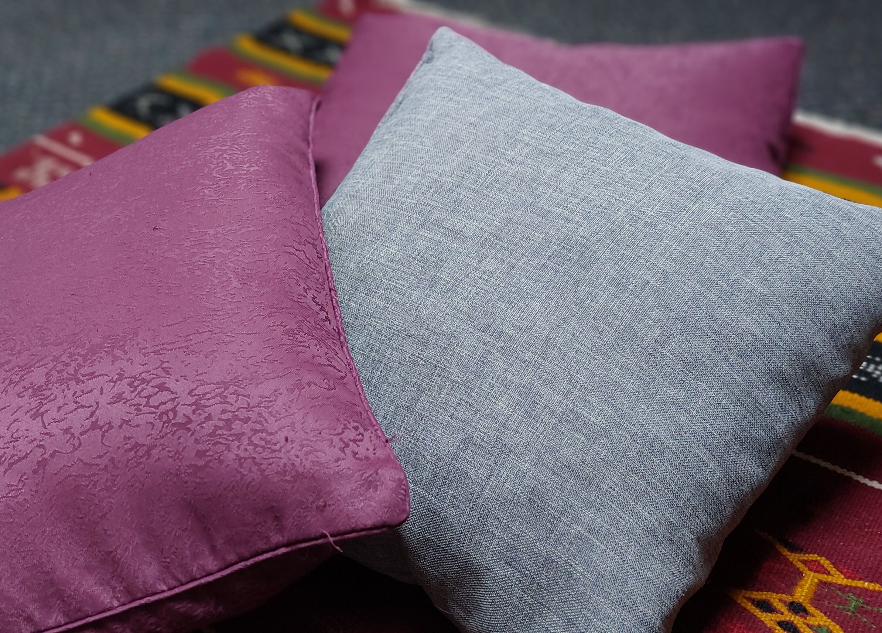 Cozy cushions on vibrant rug at City Zen Sanctuary, Edinburgh, Scotland, GB create a calming ambiance.