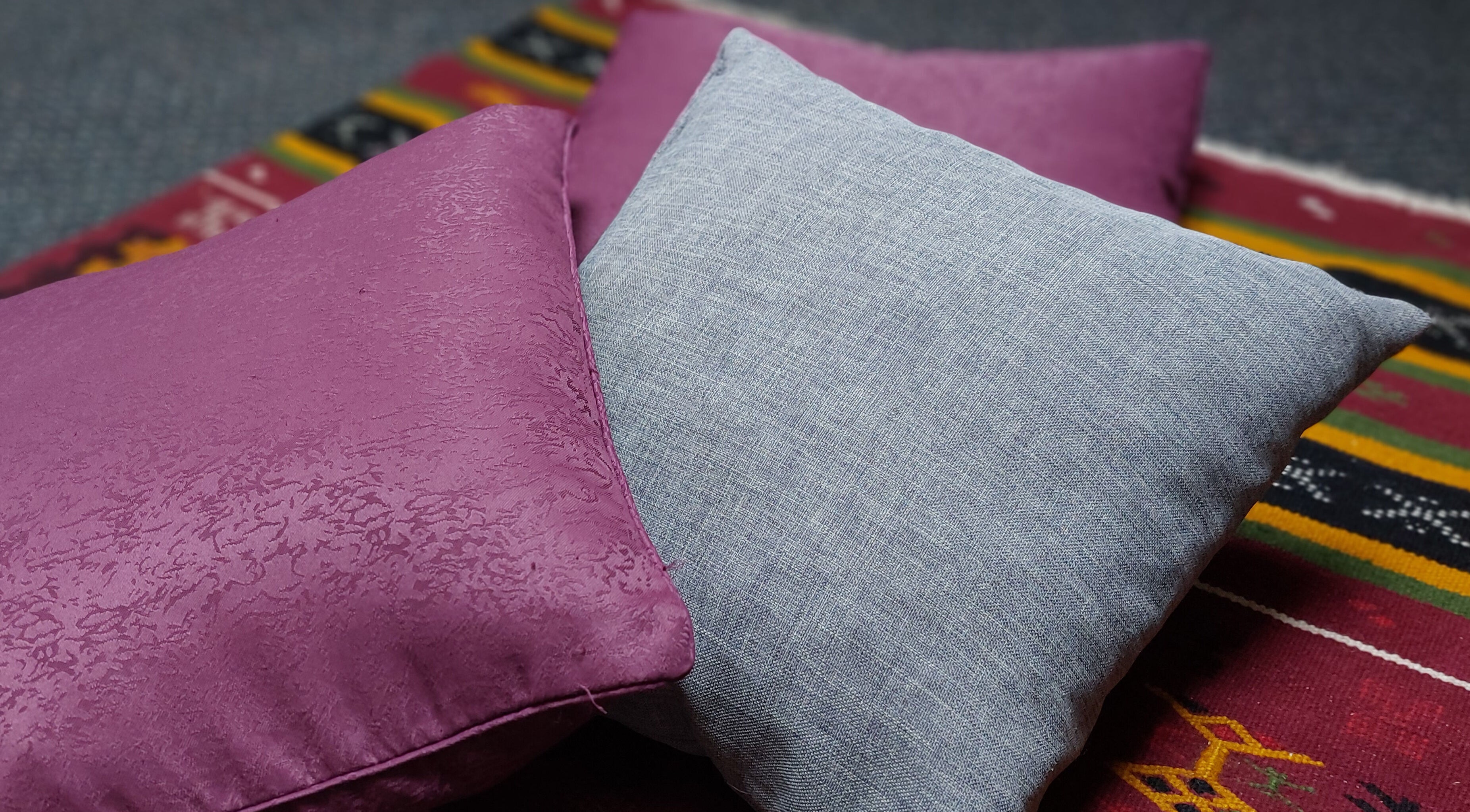 Cozy cushions on vibrant rug at City Zen Sanctuary, Edinburgh, Scotland, GB create a calming ambiance.