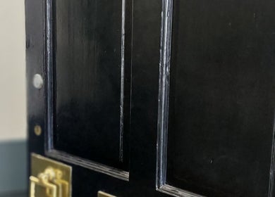 Elegant black door with golden handle at City Zen Sanctuary, Edinburgh, Scotland, GB.