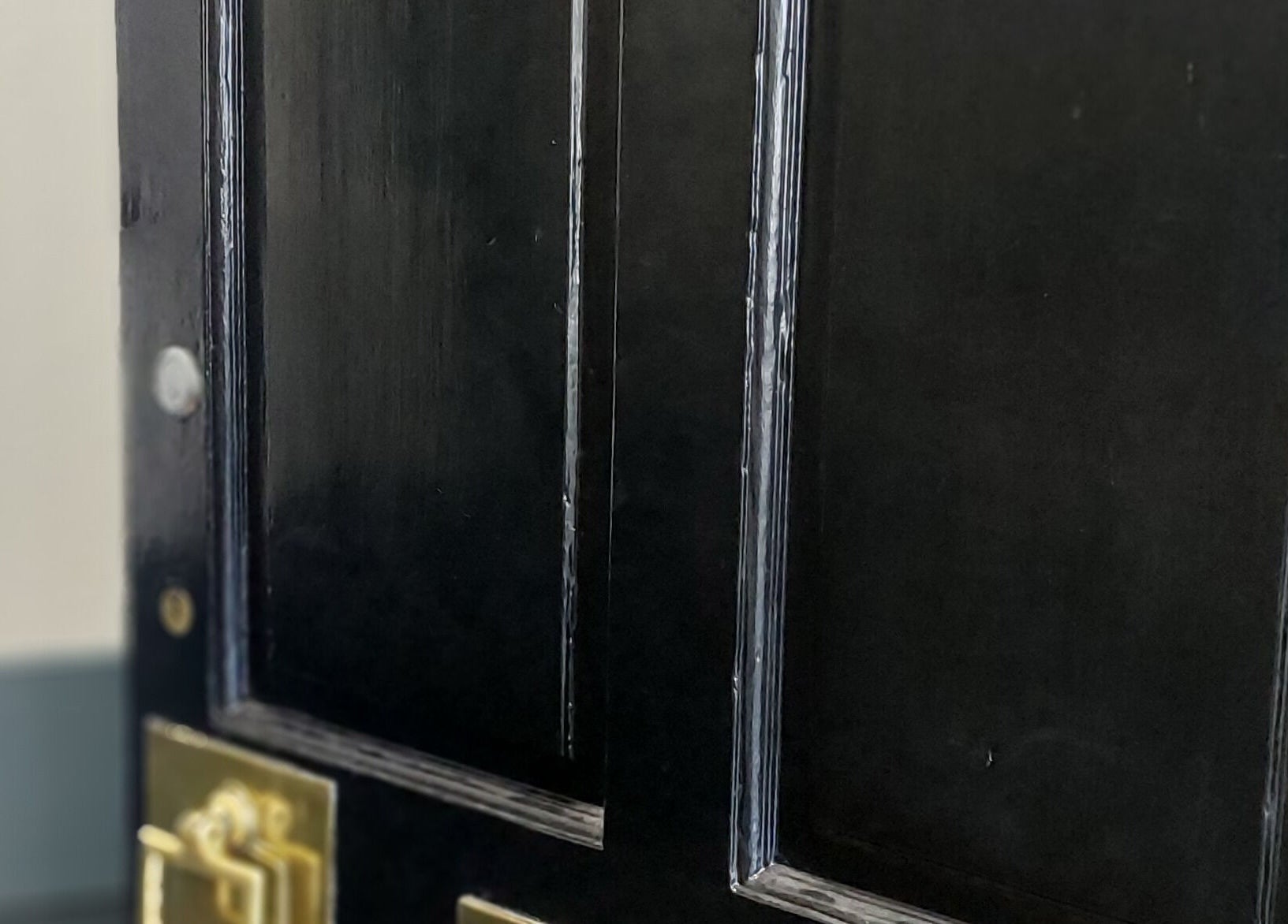 Elegant black door with golden handle at City Zen Sanctuary, Edinburgh, Scotland, GB.