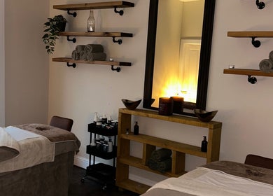 Relaxing treatment room at Croftpark House Spa, Airdrie, Scotland, GB, with plush beds and ambient lighting.