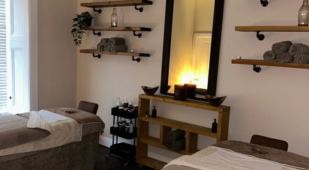 Relaxing treatment room at Croftpark House Spa, Airdrie, Scotland, GB, with plush beds and ambient lighting.