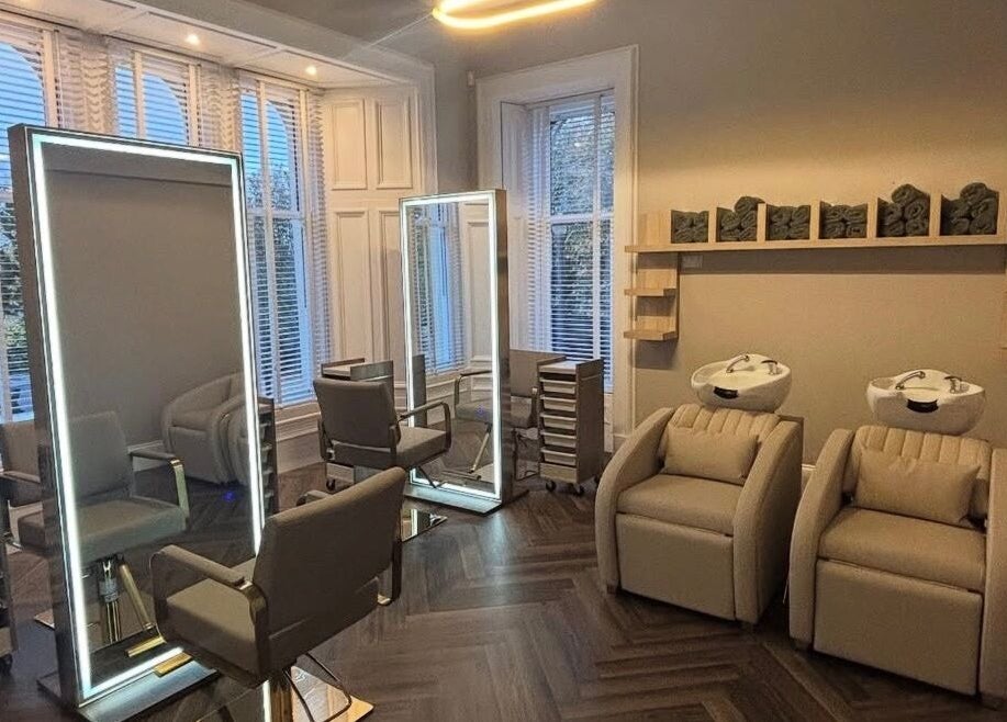 Elegant salon at Croftpark House Spa in Airdrie, Scotland, GB with modern chairs and washbasins.