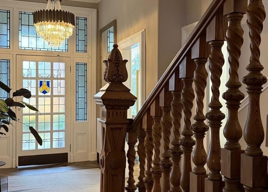 Charming staircase at Croftpark House Spa, Airdrie, Scotland, GB with ornate wooden banisters and stained glass.