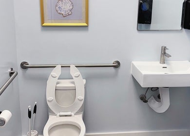 Accessible restroom at OMI MASSAGE, Lawrenceville, Georgia, US featuring clean sink and toilet facilities.