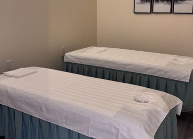 Two massage tables in the tranquil setting of OMI MASSAGE, Lawrenceville, Georgia, US.