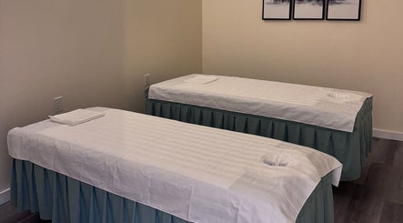Two massage tables in the tranquil setting of OMI MASSAGE, Lawrenceville, Georgia, US.