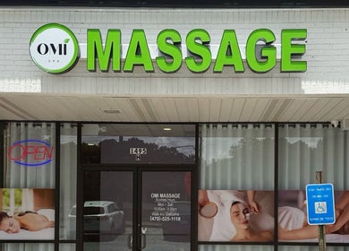 Exterior view of OMI MASSAGE in Lawrenceville, Georgia. Welcoming entrance with bright sign.