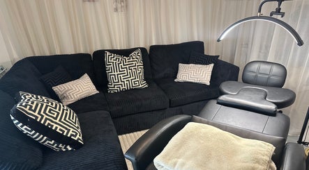 Cozy seating and treatment chair at Ink & Lam, London, England, GB for a relaxing beauty experience.