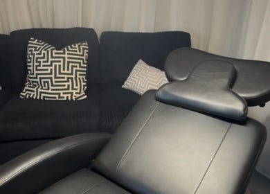 Luxurious black salon chair and couch with modern pillows at Ink & Lam, London, England, GB.