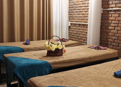 Không gian thư giãn tại Ola spa, Đà Nẵng, Đà Nẵng, VN với giường massage và hoa tươi.