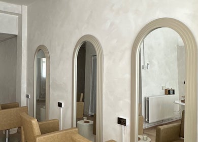 Stylish mirrors and seating at Hair By Macey Coles, Clifton, England, GB, showcasing modern salon design.