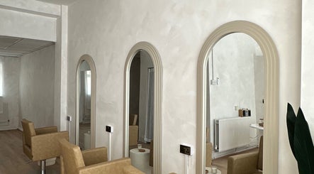 Stylish mirrors and seating at Hair By Macey Coles, Clifton, England, GB, showcasing modern salon design.
