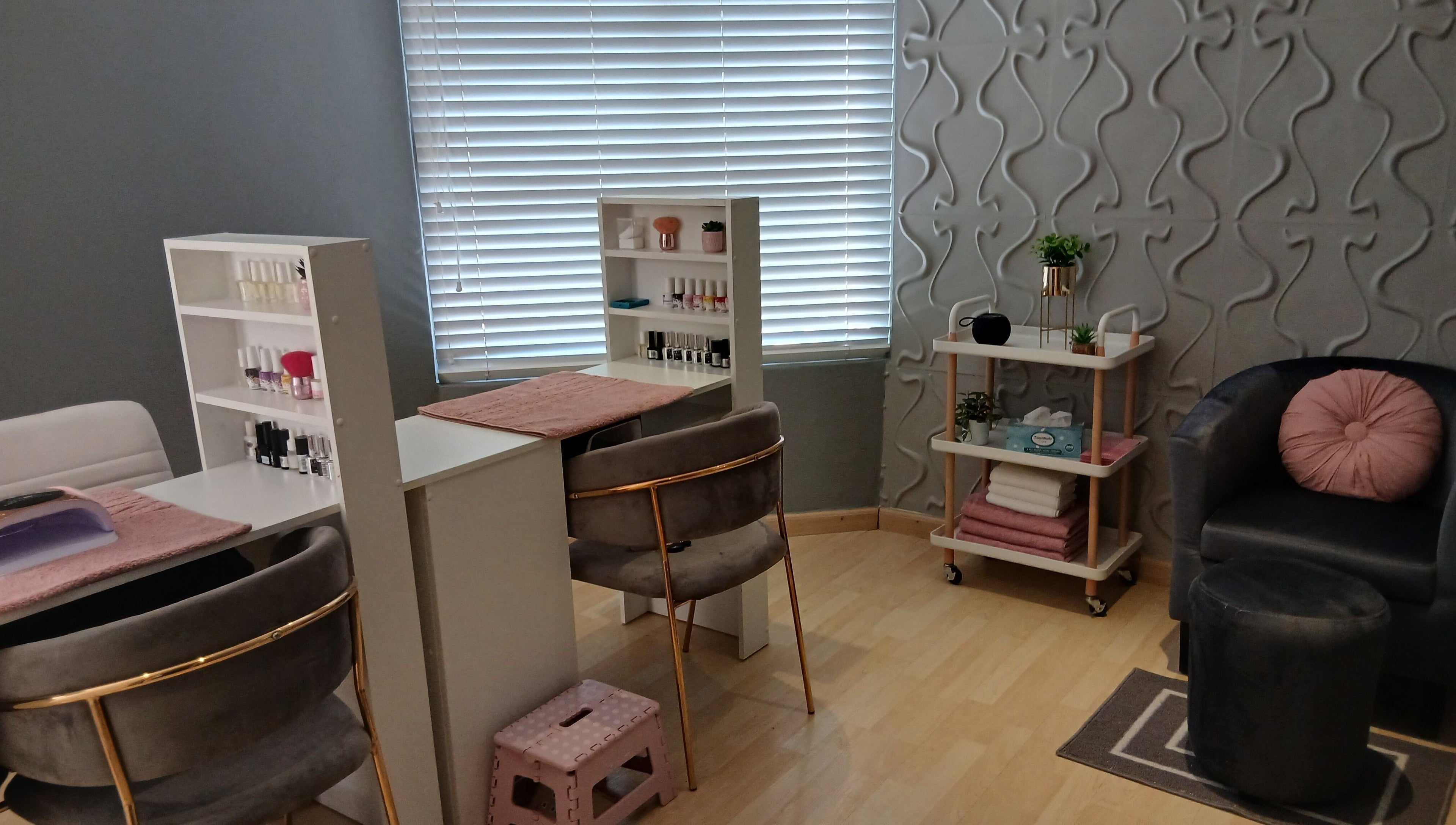 Cozy nail studio at Nails By Prim, Sandton, Gauteng, ZA with plush chairs and nail polish displays.