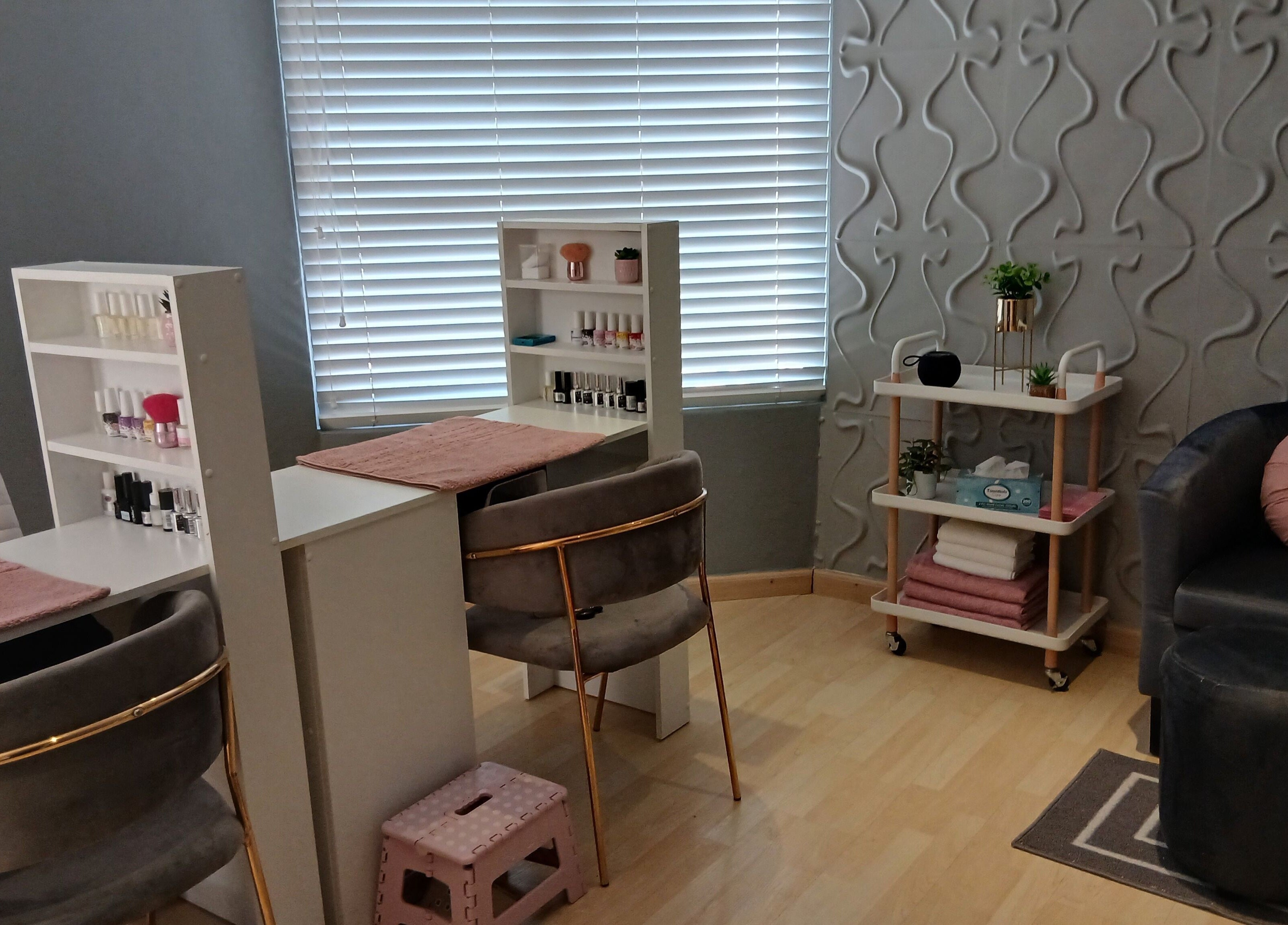 Cozy nail studio at Nails By Prim, Sandton, Gauteng, ZA with plush chairs and nail polish displays.