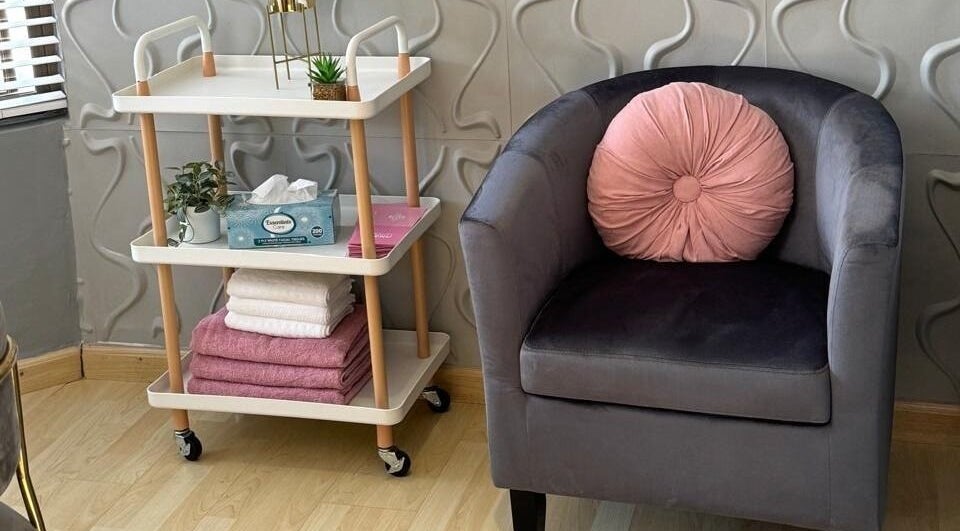 Relaxing corner at Nails By Prim, Sandton, Gauteng, ZA with plush chair and elegant decor.