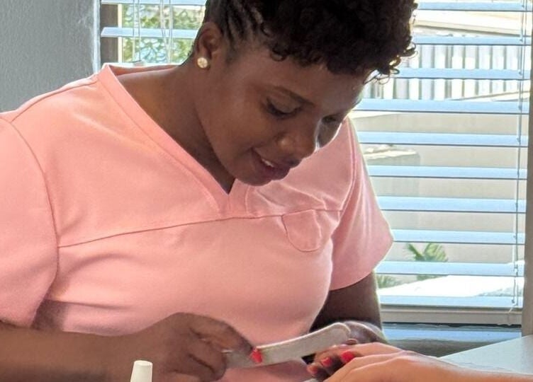 Nail technician at Nails By Prim in Sandton, Gauteng, ZA providing professional manicure service.