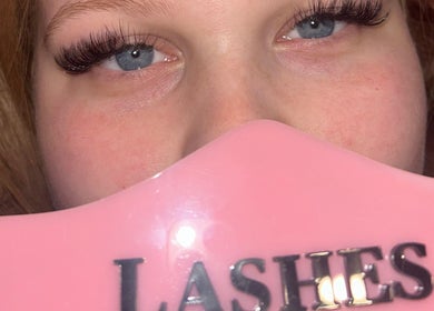 Close-up of styled lashes at Lashes by Elise, Sleaford, England, GB with pink branding sign.
