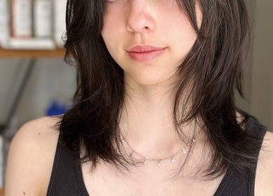 Modern hairstyle at MopheadbyMayNoh in Richmond, British Columbia, CA, showcasing layered dark hair.