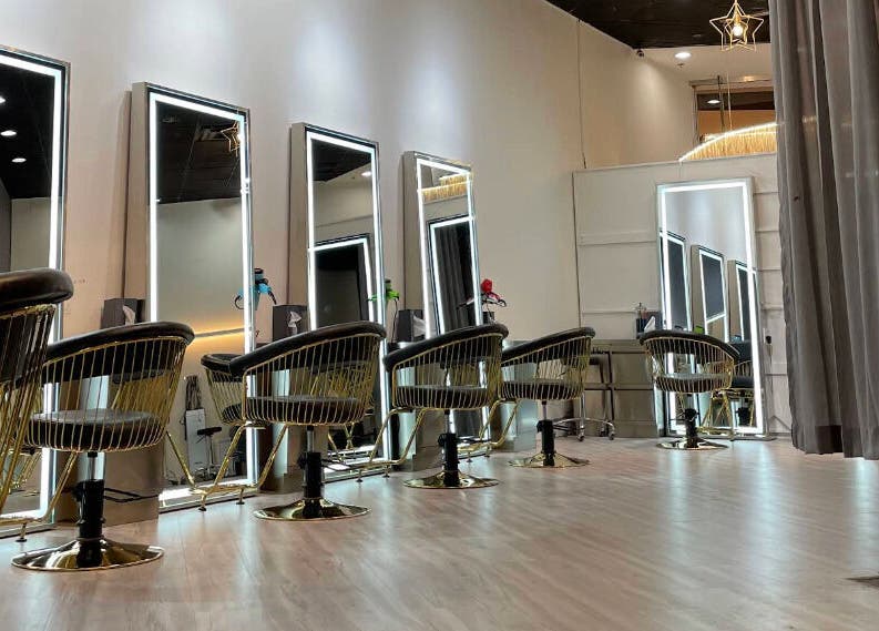 Luxurious salon interior at May Noh at Mophead in Richmond, British Columbia, CA, showcasing modern styling chairs.