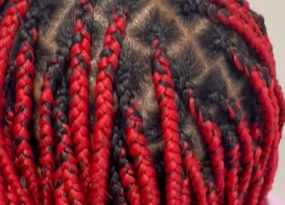 Red and black braids at Ney's Braids and Beauty, Kingsteignton, England, GB.