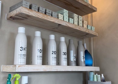 Products on shelves at Tam’s Chair, Cape Town, Western Cape, ZA showcasing premium haircare items.