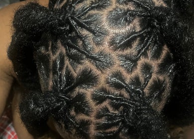 Detailed hair braiding style at The Loc Lounge in Savannah, Georgia, US, showcasing unique patterns.