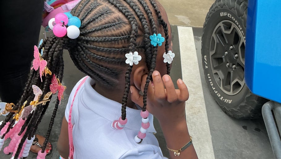 Colorful braided hairstyle with beads at The Loc Lounge, Savannah, Georgia, US.