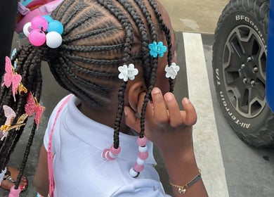 Colorful braided hairstyle with beads at The Loc Lounge, Savannah, Georgia, US.