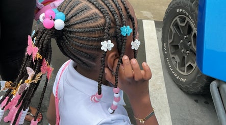 Colorful braided hairstyle with beads at The Loc Lounge, Savannah, Georgia, US.