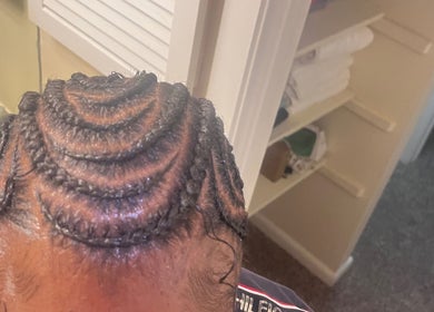 Intricate spiral braid design at The Loc Lounge, Savannah, Georgia, US, showcasing expert hairstyling.