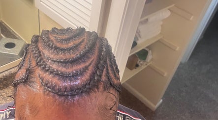 Intricate spiral braid design at The Loc Lounge, Savannah, Georgia, US, showcasing expert hairstyling.