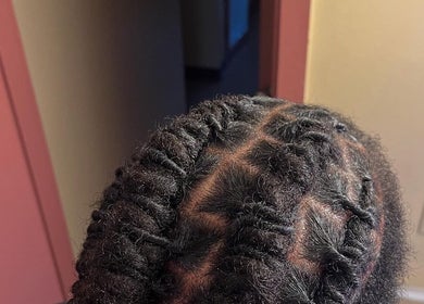Detailed braids styled at The Loc Lounge, Savannah, Georgia, US, showcasing expert hair design.