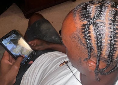 Detailed cornrows hairstyle at The Loc Lounge in Savannah, Georgia, US, showcasing intricate braiding.