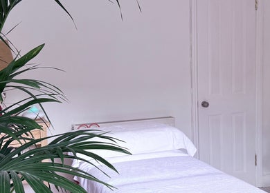 Peaceful massage room at Gem Massage Therapy, Enfield, England, GB with calming decor and massage table.