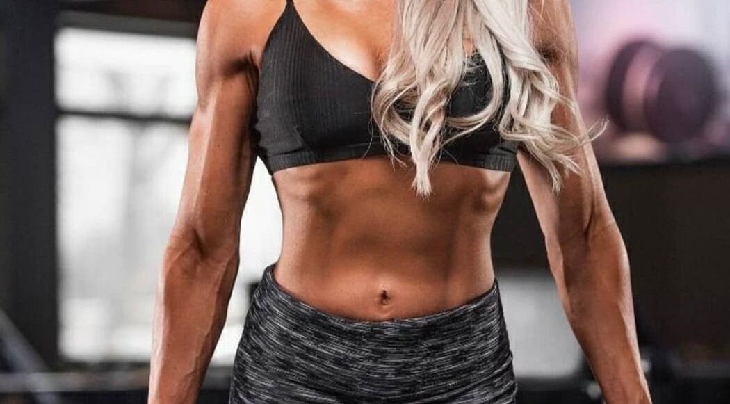 Fit woman exhibiting strength at Michelle Rörich Fitness, Ballito, Kwazulu-natal, ZA gym environment.