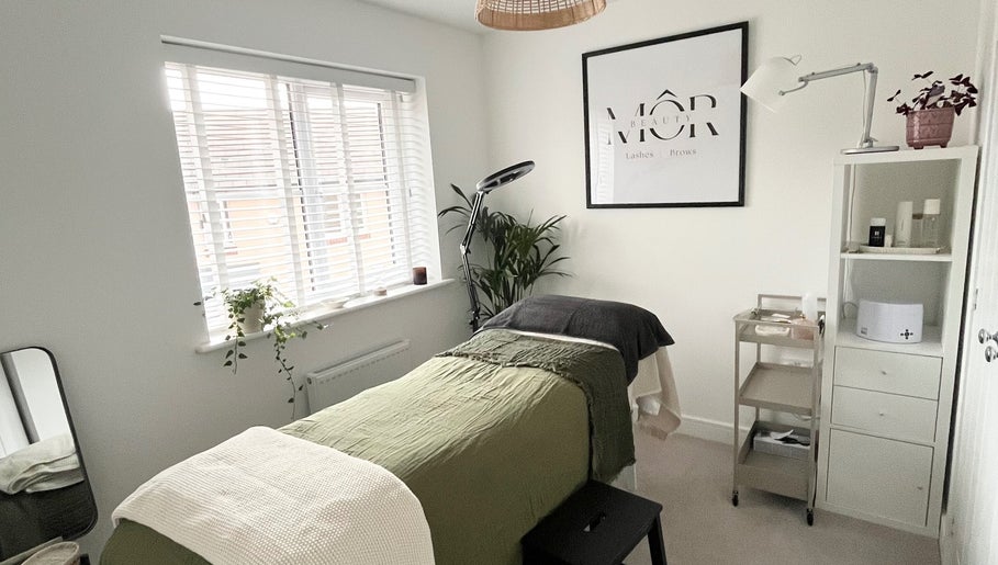 Tranquil beauty room at MÔR Beauty, Rhoose, Wales, GB with lush decor and cozy massage table.