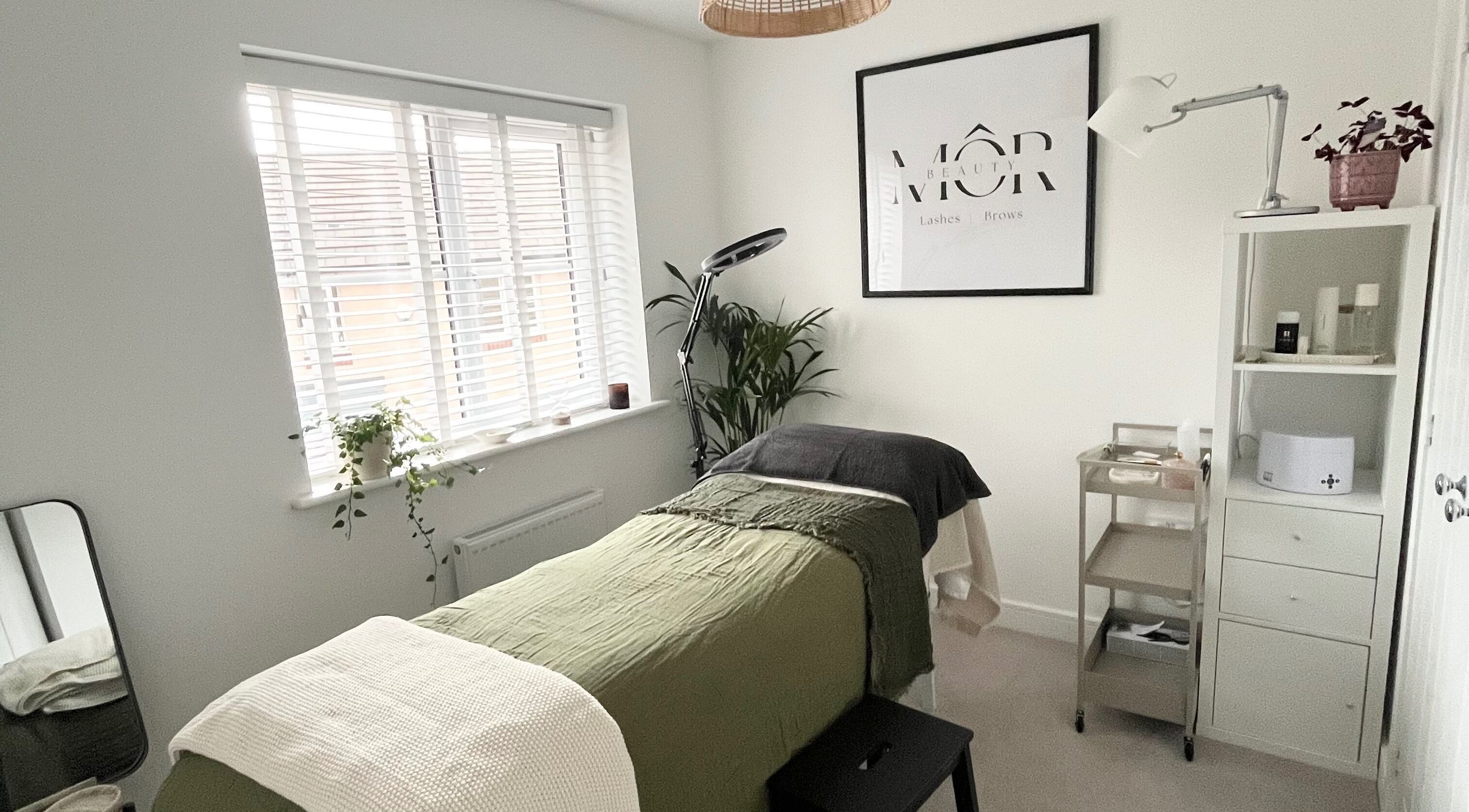 Tranquil beauty room at MÔR Beauty, Rhoose, Wales, GB with lush decor and cozy massage table.