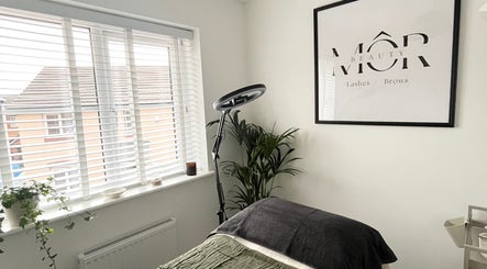 Inviting treatment room at MÔR Beauty, Rhoose, Wales, GB featuring elegant decor and a cozy setup.