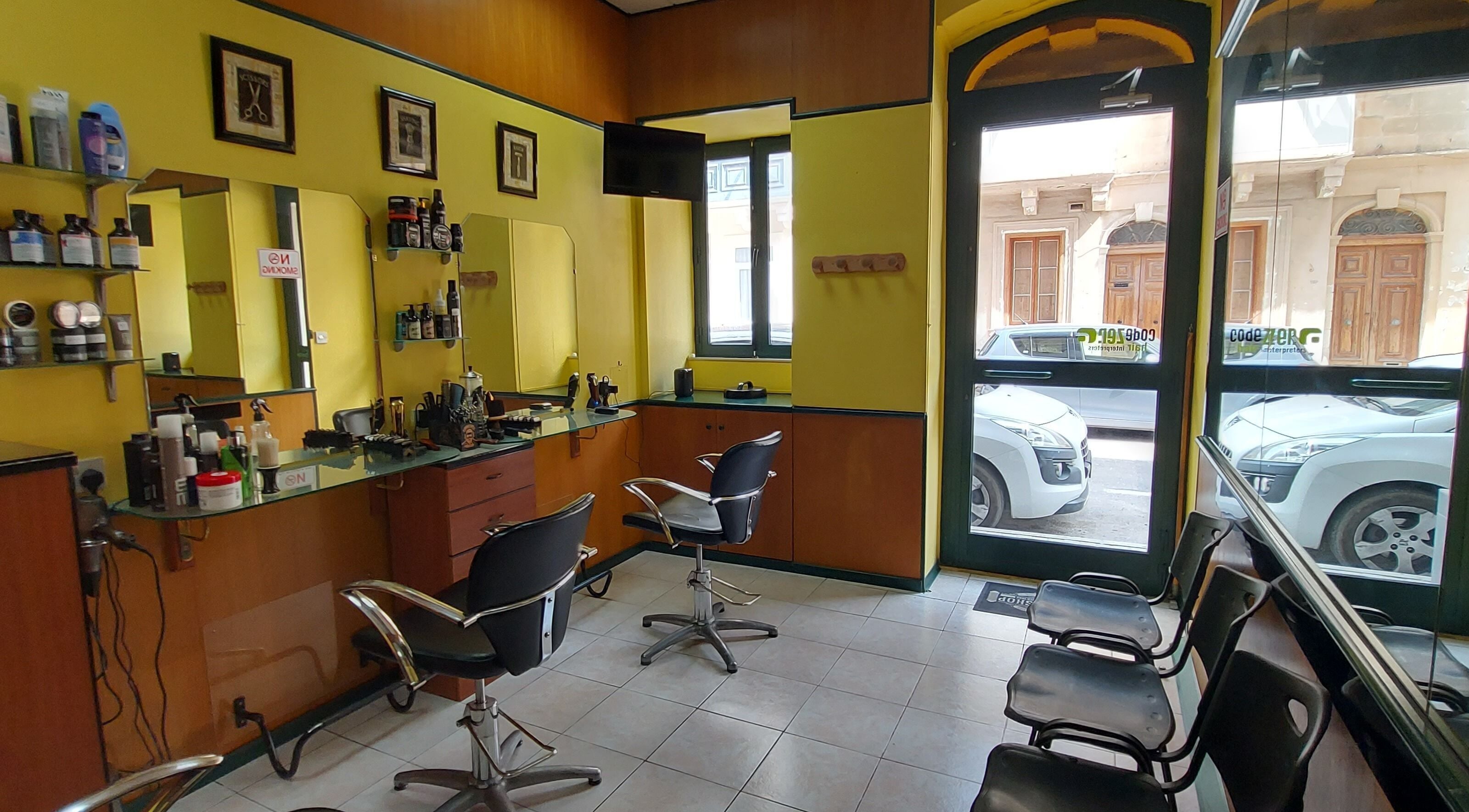 Interior of IX-XUXA Barbers in Il-gżira, MT, featuring modern chairs, mirrors, and stylish decor.