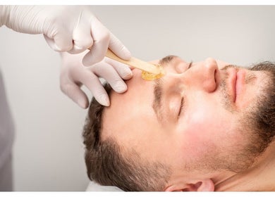 Aesthetician performs eyebrow waxing at SOLACE SPA, Miami, Florida, US, promoting precise grooming.