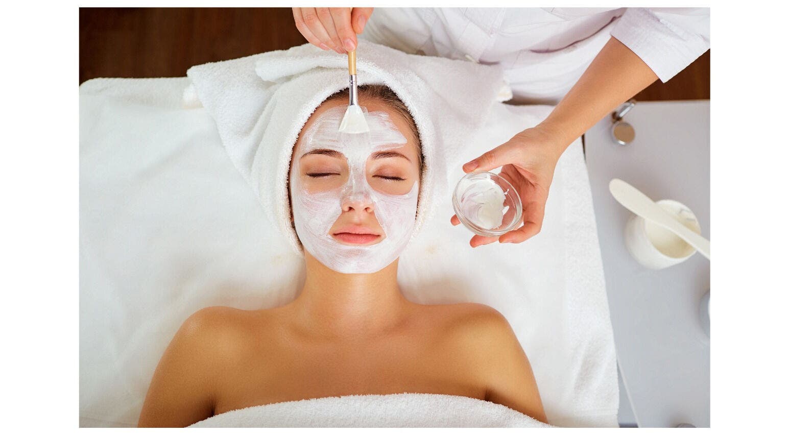 Woman receives facial mask treatment at Solace Spa, Miami, Florida, US. Relaxing beauty therapy session.