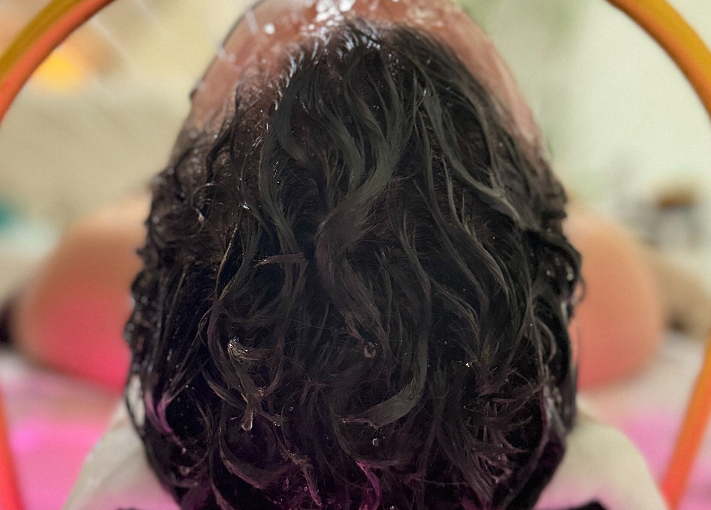 Refreshing hair treatment at Solace Spa in Miami, Florida, US, showcasing revitalized, wet hair under a shower.