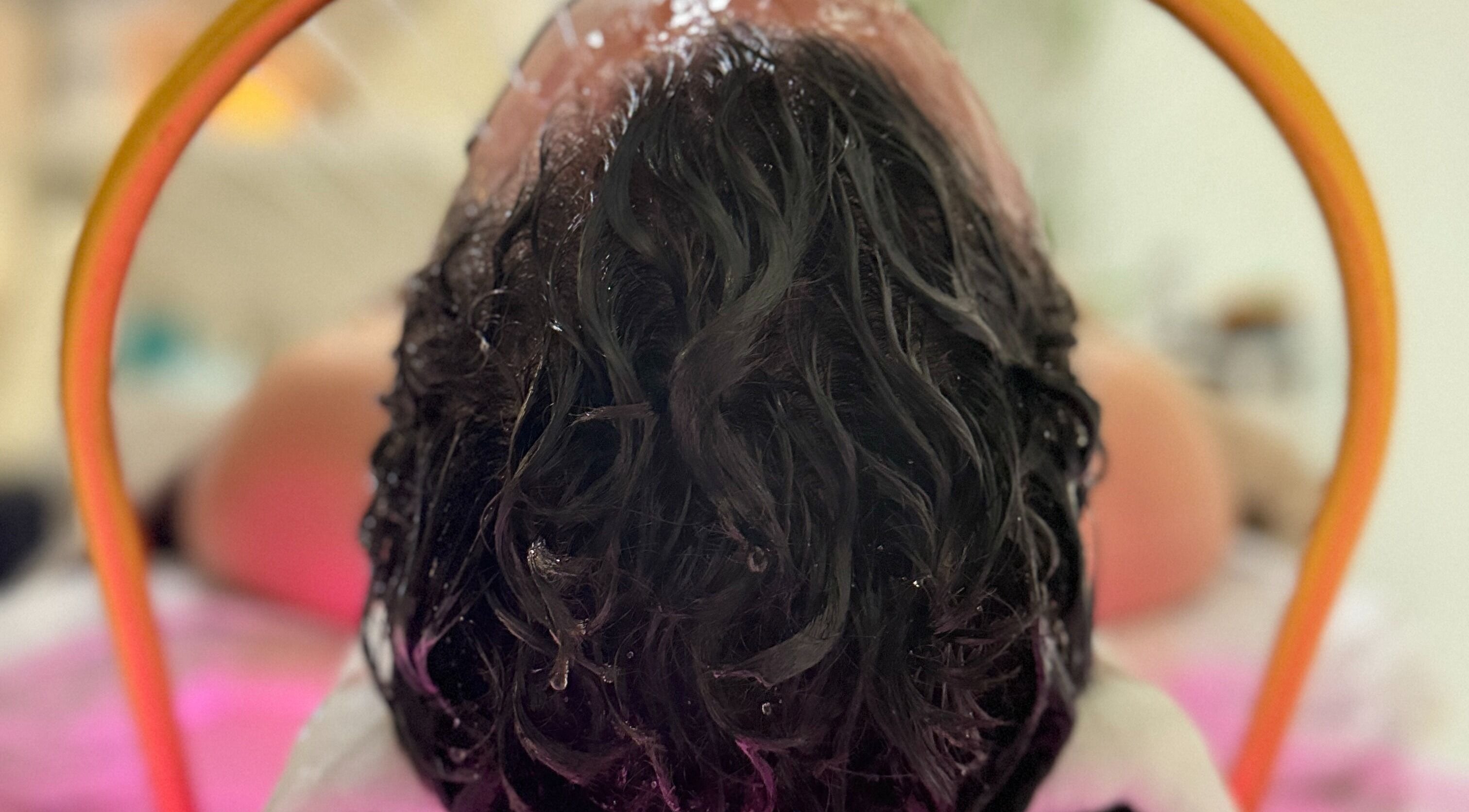 Refreshing hair treatment at Solace Spa in Miami, Florida, US, showcasing revitalized, wet hair under a shower.