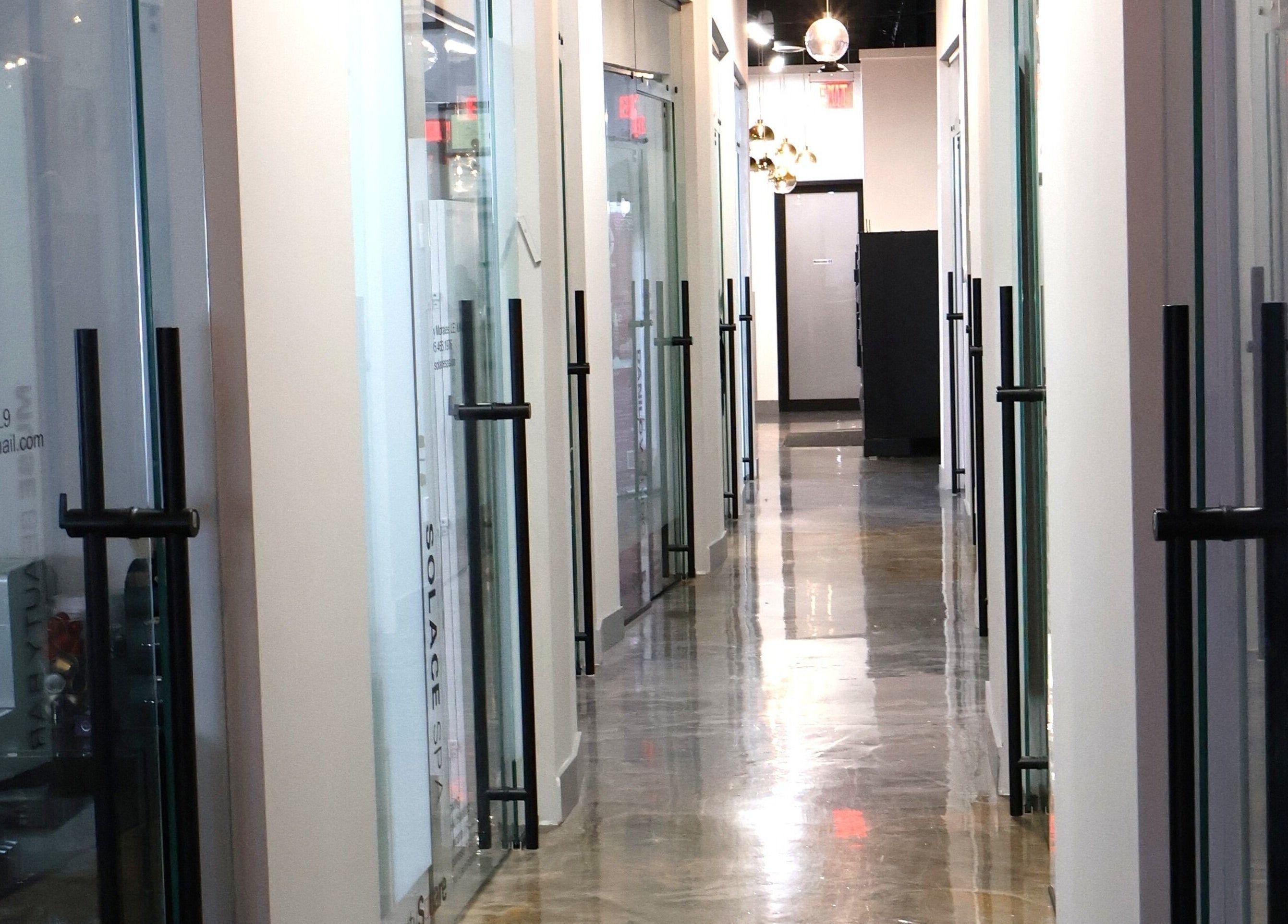 Elegant glass corridor at Solace Spa in Miami, Florida, US showcasing modern wellness design.