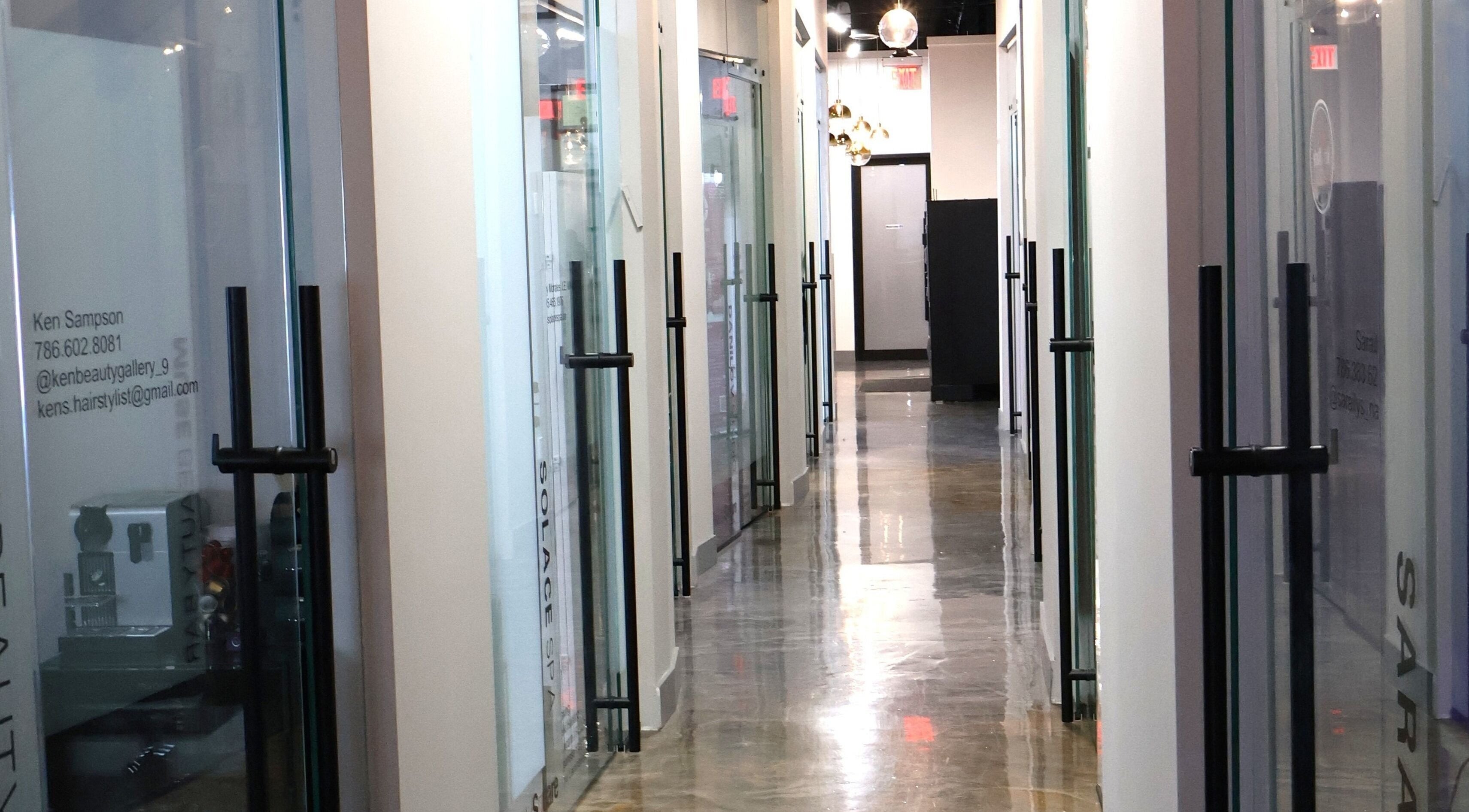 Elegant glass corridor at Solace Spa in Miami, Florida, US showcasing modern wellness design.