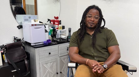 Chilly.Da.Barber at FAMA Cuts in Los Angeles, California, US, seated in a modern barbershop setup.