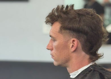 Profile of trendy mullet hairstyle at Chilly.Da.Barber (of FAMA Cuts), Los Angeles, California, US.