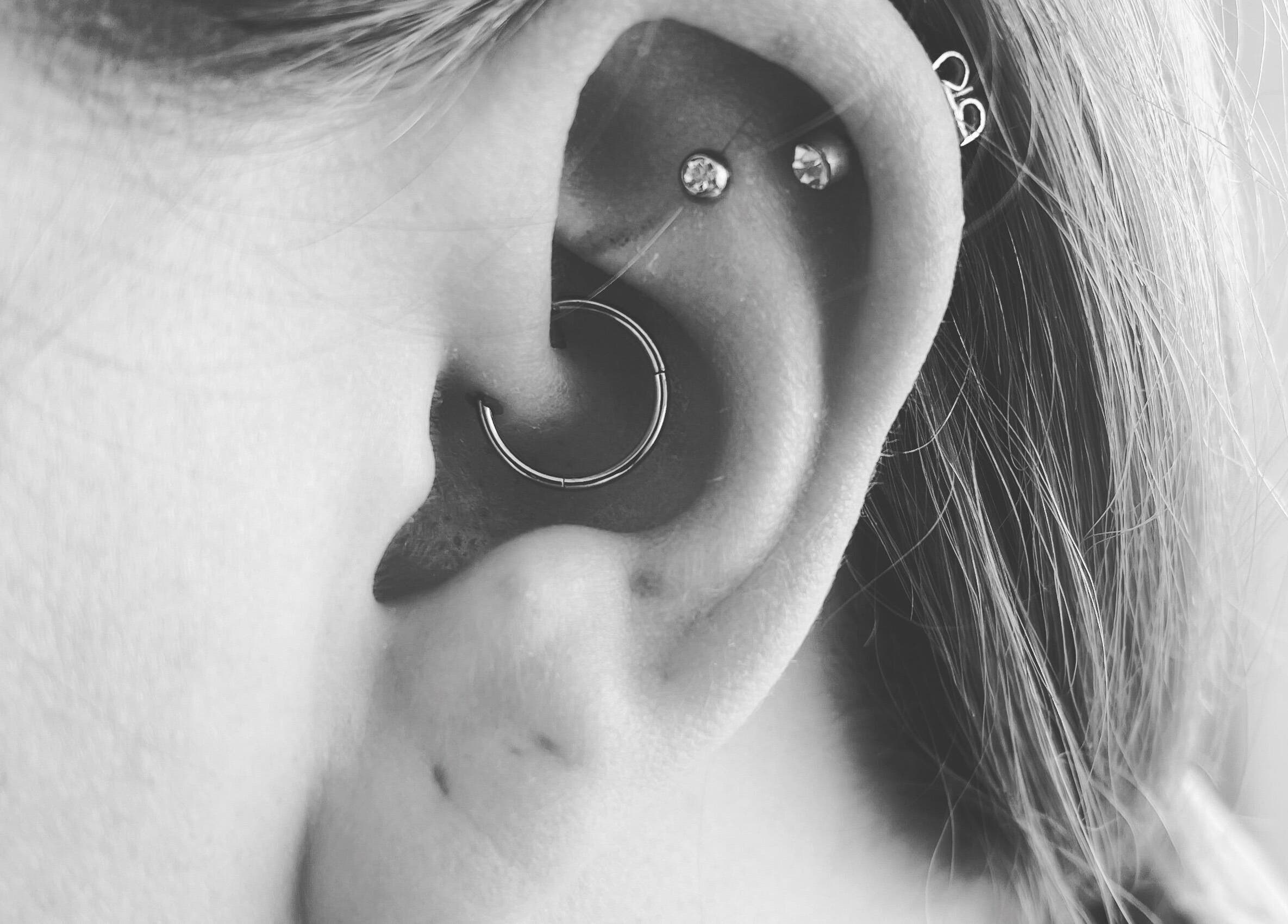 Close-up of ear piercings at Thy Eternal in Hayle, England, GB showcasing stylish jewelry.